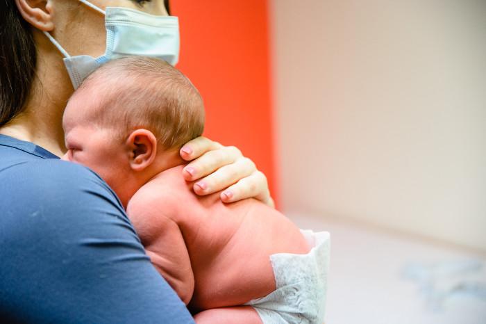 baby on a woman's shoulder